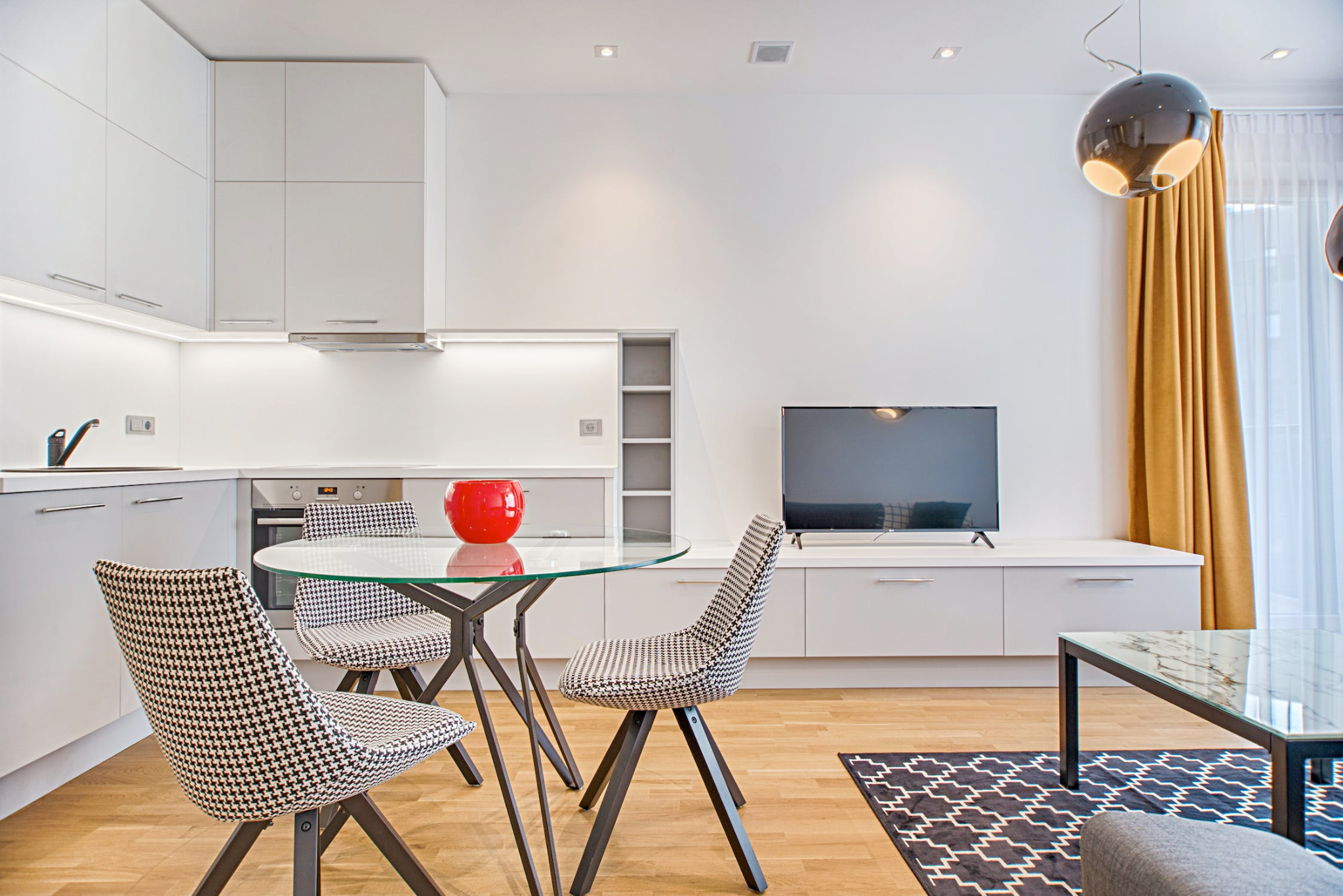 An image of a living room with a glass table