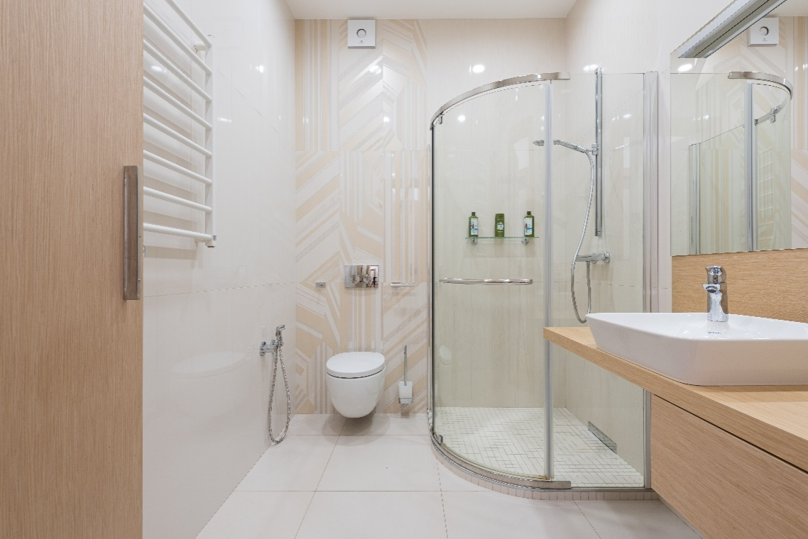 bathroom with shower cabin and wooden furniture