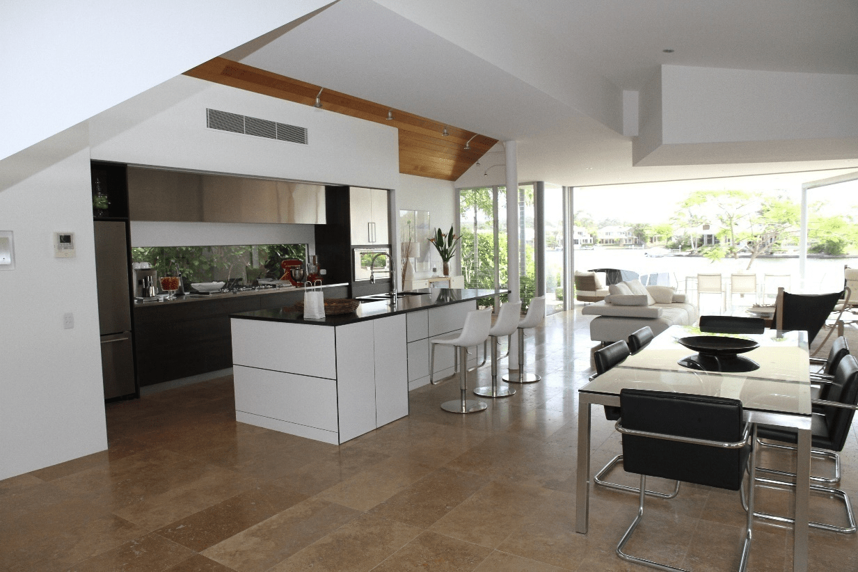 White wooden dining table with chairs in a kitchen